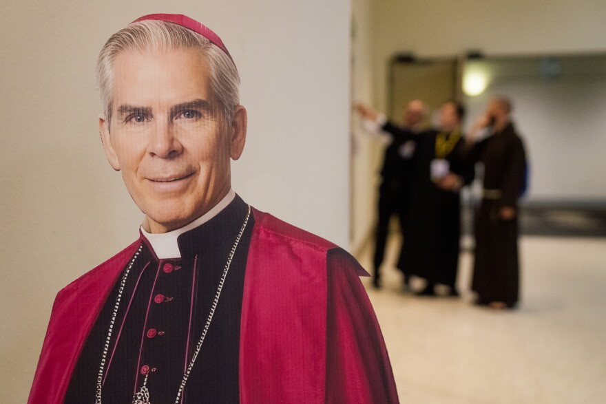 Seminarians look for directions behind a cutout of the late Archbishop Fulton J. Sheen ahead of his beatification Mass on Thursday at the Dome at America's Center in downtown St. Louis.