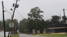 Power pole leaning over a road after Hurricane Irma.