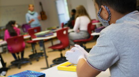 A sixth grader wears a protective face mask and gloves as he attends class for the first time since March at the GutsMuths Grundschule elementary school during the novel coronavirus crisis on May 4, 2020 in Berlin, Germany. (Sean Gallup/Getty Images)