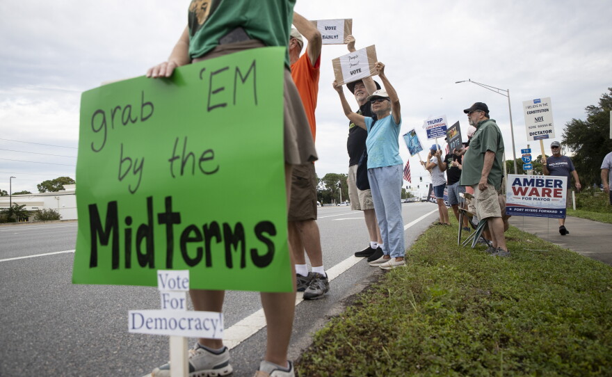 People gather along U.S. 41 in Fort Myers on Saturday morning, October 17, 2026, to advocate for change ahead of the mid-term elections. Organizers estimate about 1,000 people came out for the event.