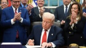 President Donald Trump signs the funding bill to reopen the government, in the Oval Office of the White House, Wednesday, Nov. 12, 2025, in Washington.