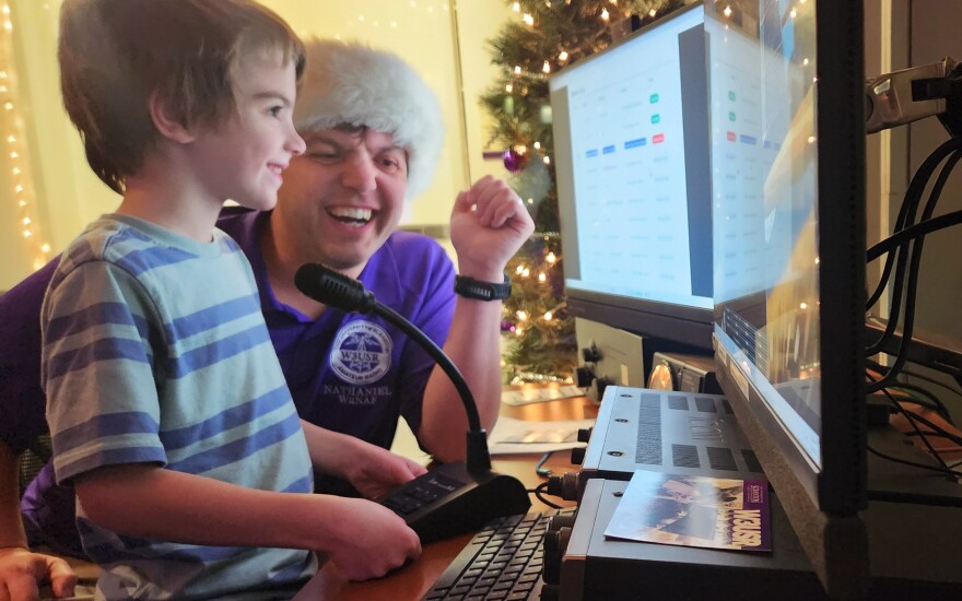 Anthony Frissell, 6, and his dad, Nathaniel Frissell, associate professor of physics and engineering at the University of Scranton, speak to Santa at the school's amateur radio station.