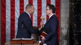  US House Minority Leader Hakeem Jeffries(L) hands newly elected House Speaker Mike Johnson the gavel at the US Capitol in Washington, DC.