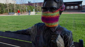 A statue of Orville Redenbacher in downtown Valparaiso with a knit mask over its face.