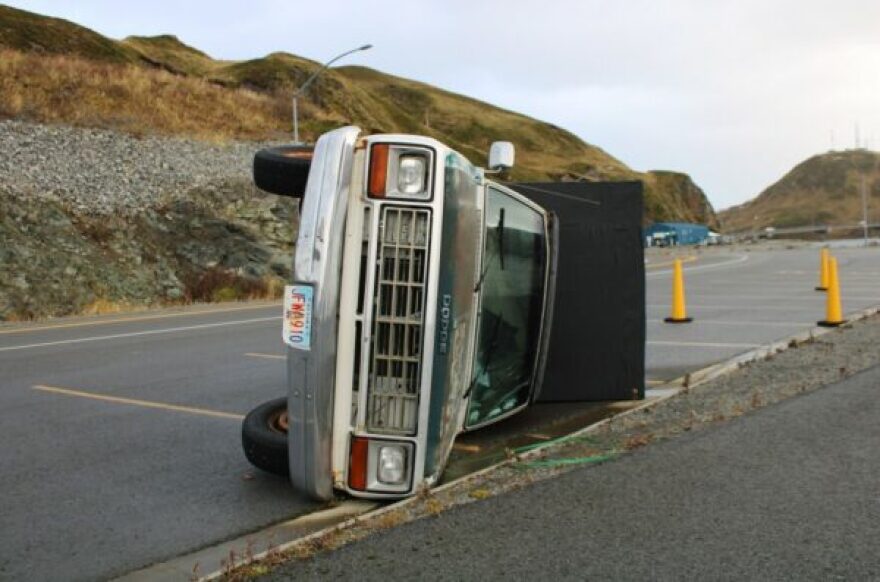 A dodge truck is toppled over.