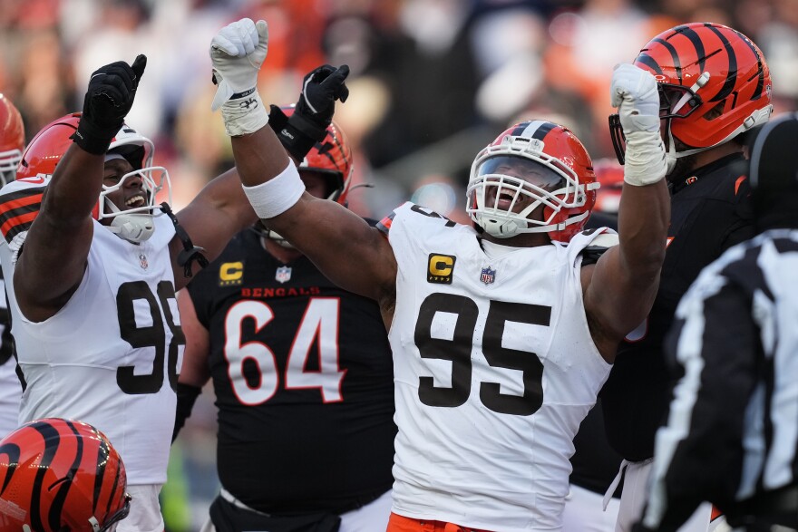 Cleveland Browns defensive end Myles Garrett (95) celebrates with defensive end Adin Huntington (98) after sacking Cincinnati Bengals quarterback Joe Burrow to set an NFL record for sacks in the regular season during the second half of an NFL football game, Sunday, Jan. 4, 2026, in Cincinnati.