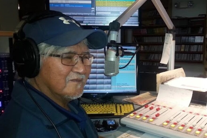 a man sitting at a microphone