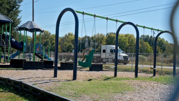 An 18-wheeler drives by the playground at Holly Ridge Elementary School in Holly Ridge, Louisiana, on Friday, October 17, 2025. The school shut down the playground this year over safety concerns due to trucks heading to the Meta construction site, less than a mile away from the school.