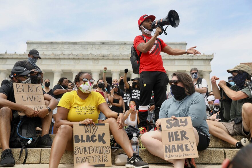 Rico Silva speaks to the crowd gathered at the Lincoln Memorial, during a peaceful protest against police brutality Saturday in Washington, D.C.