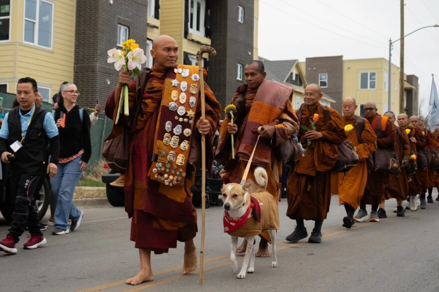 Buddhist monks walk down Ramey Avenue after getting off their bus in front of Eastover Park in Fort Worth on Feb. 14, 2026.