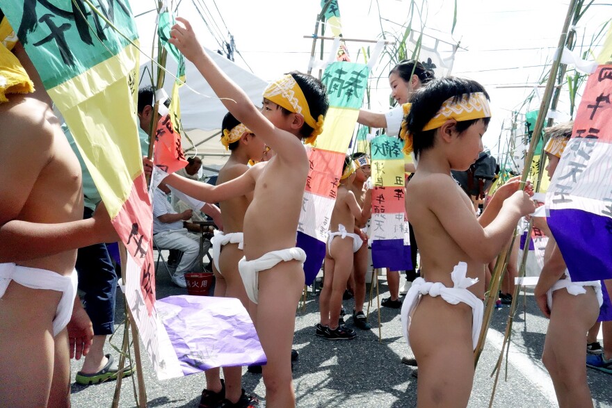 Boys ranging from six to 12 prepare their flags for the Shimadachi Hadaka Matsuri, an annual festival rooted in Shinto tradition in which the children parade through town to ward off evil spirits and pay respects to the god of health.