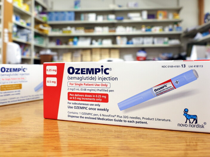 A box containing Ozempic sits on a counter.