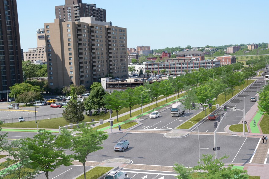 A digital art picture shows the expected re-design of the Almond and Harrison street intersection in Syracuse is surrounded by medians filled with trees and sidewalks.