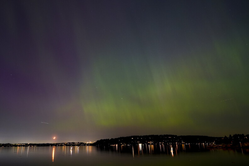 The northern lights, or aurora borealis, are visible over Lake Washington, in Renton, Wash.