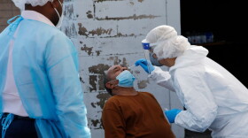 A nurse administers a coronavirus test at a COVID-19 testing site set up by Harvard Street Neighborhood Health Center at Prince Hall Grand Lodge in Grove Hall in Dorchester on Oct. 22, 2020. (Jessica Rinaldi/The Boston Globe via Getty Images)