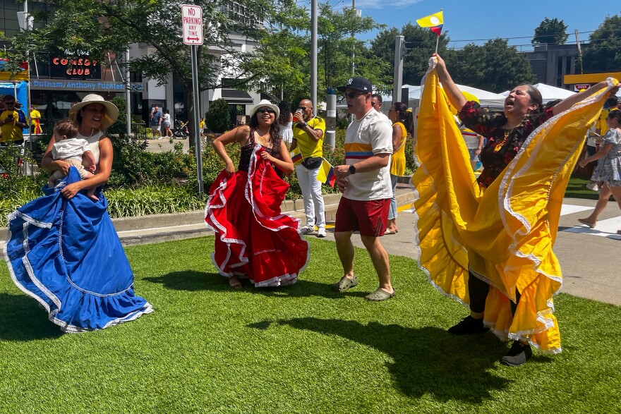 Elsa Bohorquez (right) dances to vallenato, a Colombian folk genre of music, with her two daughters Cielo Urrego (mid-left) and Gina Bohorquez (left), her son-in-law and her grandchild. The family came down from Bridgeport to celebrate Colombian Independence Day in Stamford. Bohorquez said, "Even though I have to work [in the morning], I’m here to enjoy.”