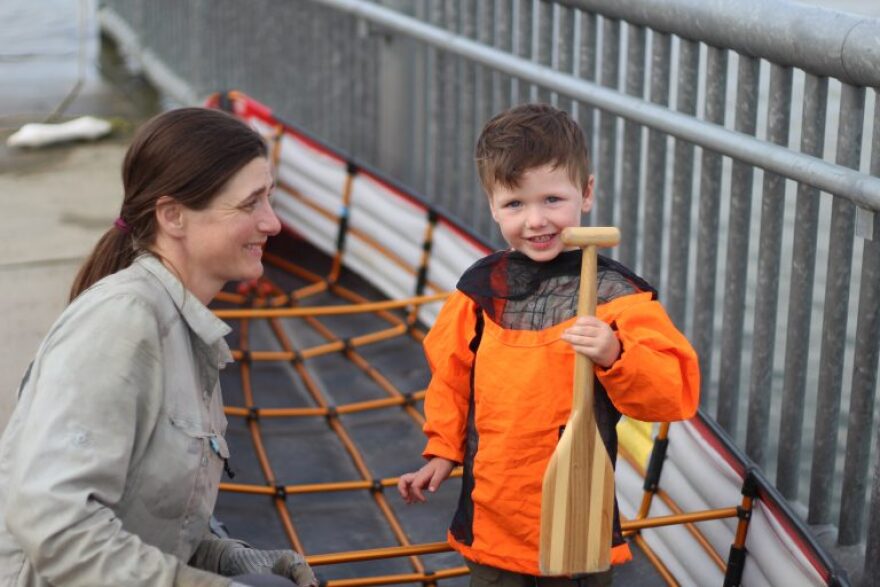 Claire Porter and her son Dashwa Paulsen stand in a canoe after floating down the Noatak River. (Wesley Early/KOTZ)