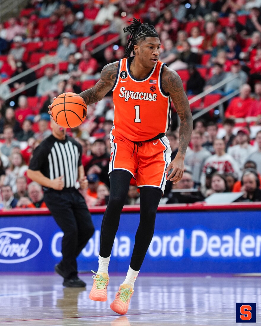 Donnie Freeman (1, Orange) dribbles from the top of the key at NC State.