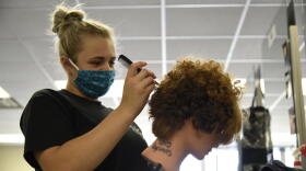 A cosmetology student at the AK Smith Career Center in Michigan City works on a mannequin for a class assignment.
