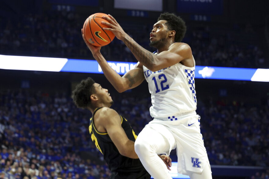 Kentucky's Keion Brooks Jr. (12) shoots over Missouri's Ronnie DeGray III (21) during the first half of an NCAA college basketball game in Lexington, Ky., Wednesday, Dec. 29, 2021. (AP Photo/James Crisp)