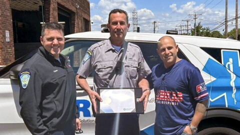 An undated photo shows Scott Montellaro, a paramedic field training officer at American Medical Response New Haven's offices. as he received an award for 30 years of service. Montellaro is in the middle, flanked from right to left by Dave Laspino, an AMR Paramedic Supervisor and Clinical Education Supervisor, and Michael Turcio an AMR Operations Manager, New Haven.
