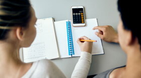 stock image of students working together on mathematics assignment