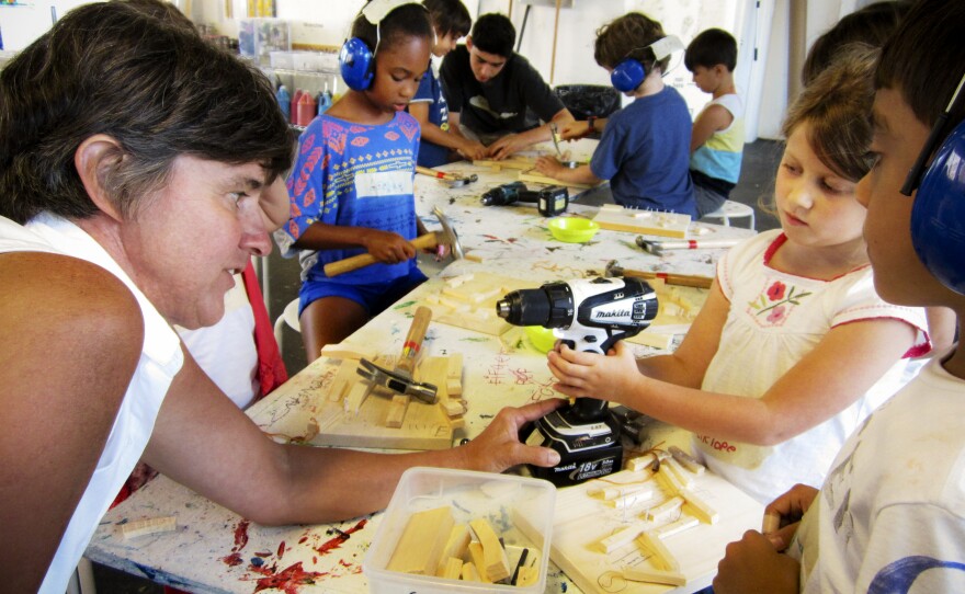 Deb Winsor, the founder of Construction Kids, works on projects with some of the students, including 7-year-old Penelope Day.