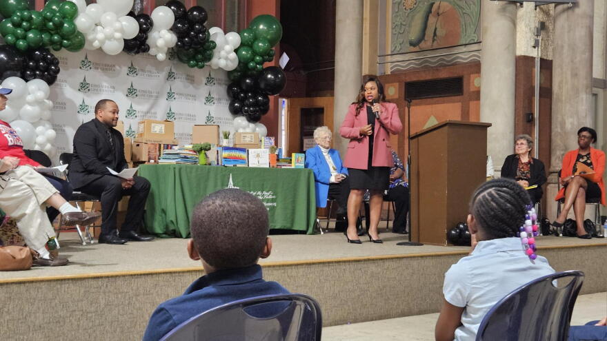 King Center Charter School Executive Director Tamaira Barlow speaks to students and the community at Project Flight's book donation event.