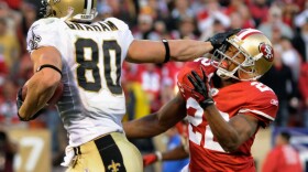 Jimmy Graham of the New Orleans Saints stiff-arms Carlos Rogers of the San Francisco 49ers during a playoff game in San Francisco on Jan. 14. The Saints reportedly gave out bounties to players who attempted to knock out players on opposing teams.