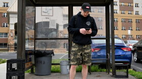 Nathan Lund, 30, a Harrisburg resident, waits for the bus on April 13, 2022. He takes a Capital Area Transit bus from N. 6th and Calder streets to the Amazon fulfillment center in Carlisle where he works. 