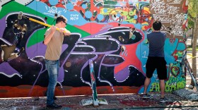 Students take sledgehammers to a replica of the Berlin Wall at New College of Florida, November 8, 2019.