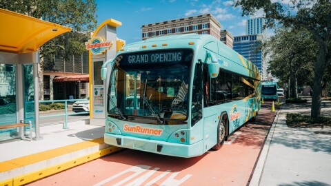 Light blue SunRunner bus at bus stop 