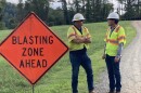 Inspector Travis Goode and spokesman Westley Kern stand by as the Rivanna Water and Sewer Authority prepares to blast through rock that's blocking a pipeline's path.