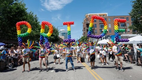 Participants carry balloons spelling out "Pride" during the 51st LGBTQ Pride Parade in Chicago on June 26, 2022.