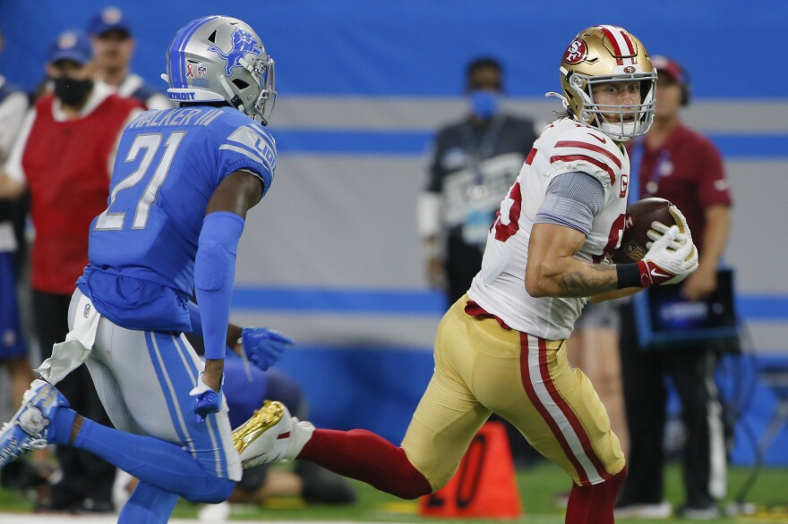 San Francisco 49ers tight end George Kittle, right, is pursued by Detroit Lions defensive back Tracy Walker III during a 2021 meeting in Detroit.