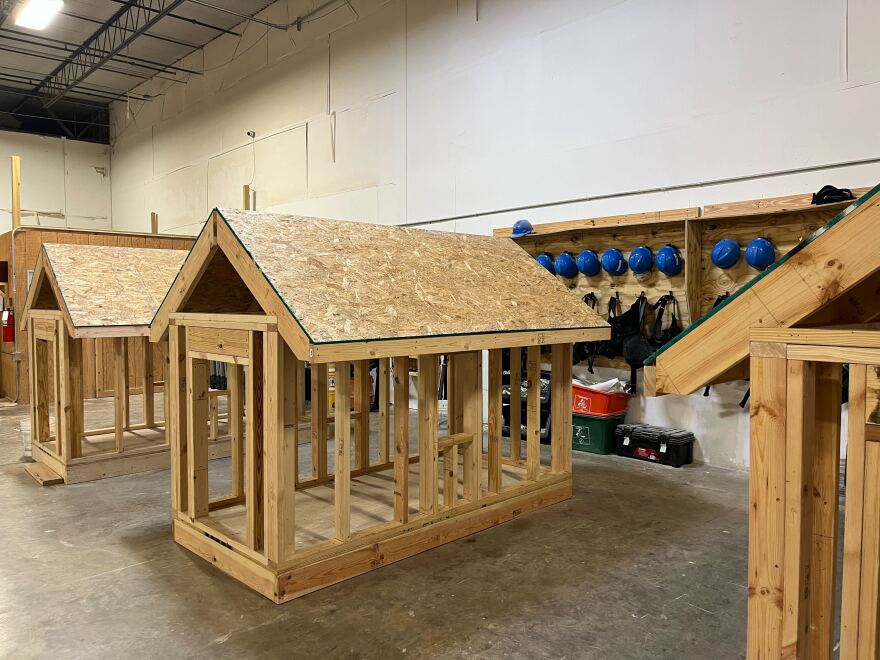 Miniature models of homes students use to practice building and repairing roofs.