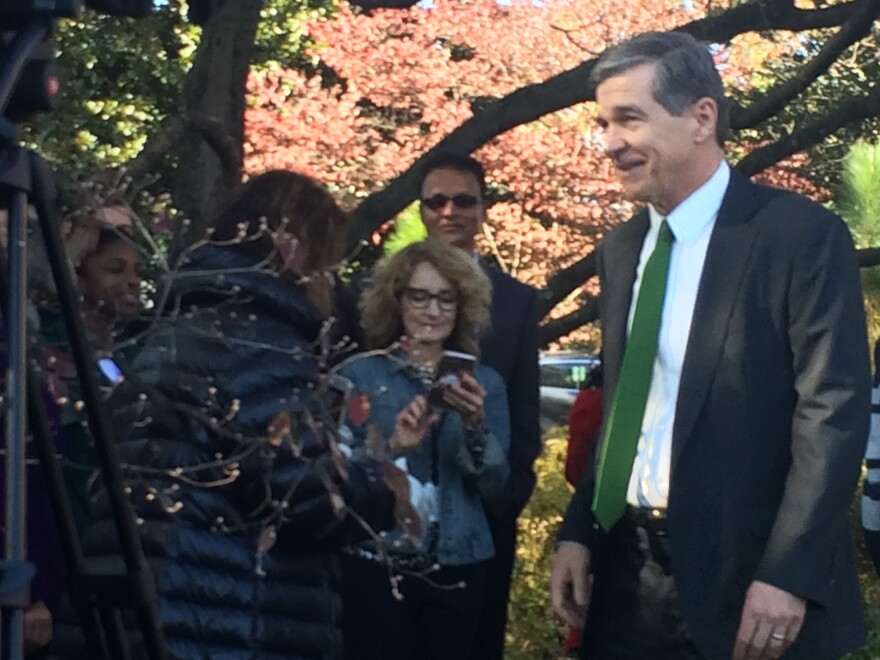Gov. Roy Cooper greeted visitors attending a pre-Thanksgiving turkey pardoning event at the governor's mansion on Thursday, the same day a legislative inquiry concluded he improperly interfered with the state permitting process for the Atlantic Coast Pipeline project.
