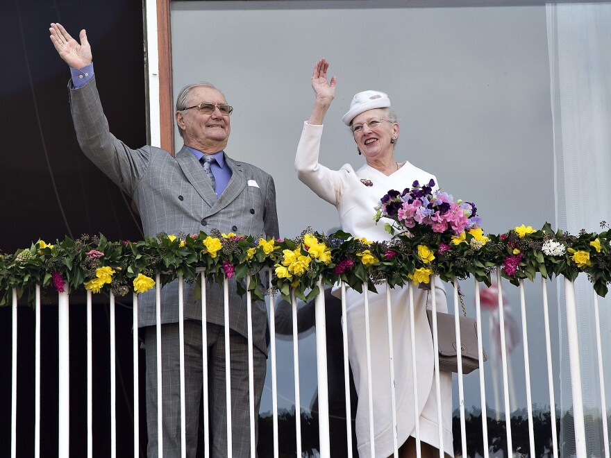 Danish Queen Margrethe and Prince Consort Henrik wave from the balcony at Aarhus City Hall in 2015 before a celebration of Queen Margrethe's 75th birthday.
