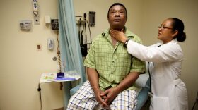 A patient receives a checkup from a doctor at the South Broward Community Health Services clinic in Hollywood, Florida.