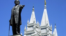  A statue of Brigham Young, second president of the Church of Jesus Christ of Latter Day Saints stands in the center of Salt Lake City with the Mormon Temple spires in the background 19 July 2001. (George Frey/AFP via Getty Images)
