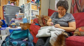 Karen Mitchell sews a parka at her mother-in-law's house in Noatak. (Hillman/Alaska Public Media)
