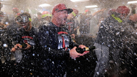 Cleveland Guardians manager Stephen Vogt center, celebrates with his team after clinching a post season playoff spot following a baseball game against the Boston Red Sox, Thursday, Sept. 24, 2026, in Boston.  