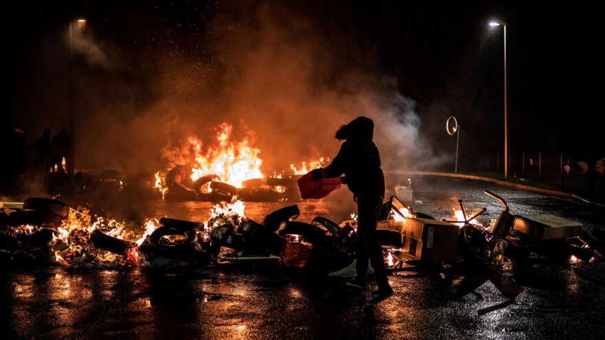 Striking prison guards light a fire as they demonstrate in front of Villefranche-sur-Saone prison on Monday as part of a nationwide movement to call for improved safety and wages.