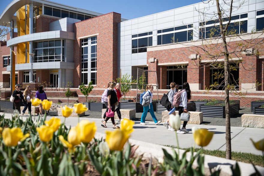 Students walk past the Rhatigan Student Center on campus at Wichita State University on April 6, 2026. Kansas Regents approved tuition hikes at Wichita State and four other state universities. 