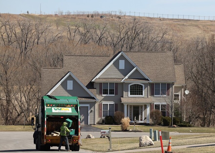 A Waste Management truck collects recyclables in a Perinton neighborhood near the High Acres landfill.