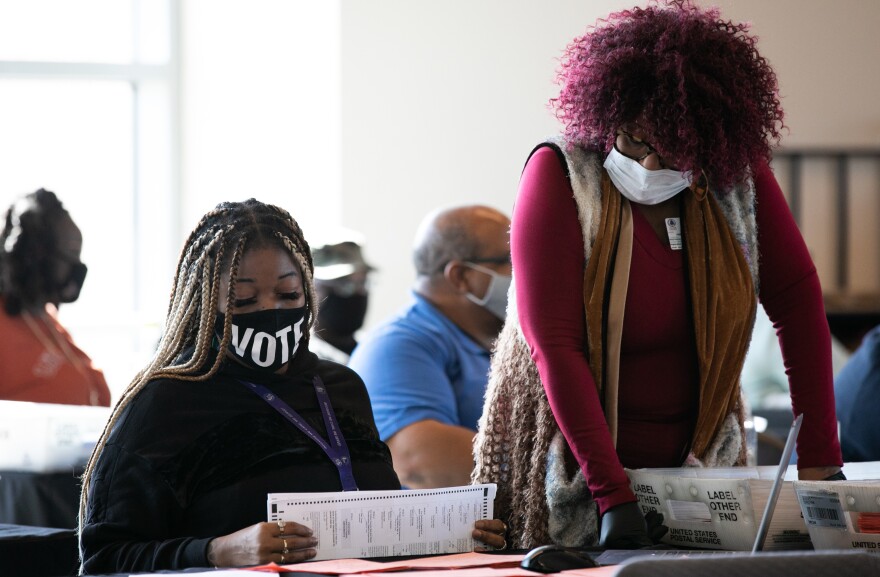 Fulton County workers count absentee ballots on Nov. 6, 2020, in Atlanta. A judge's order marks the latest challenge for the county in a seemingly never-ending election cycle.