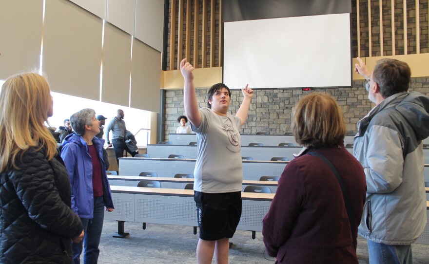 State High senior Nick Gibson tells his tour group about the projectors in one of the new lecture halls at State High.