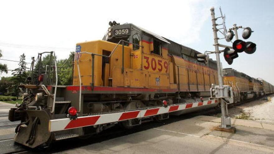 A Union Pacific freight train passes over a grade crossing in Elmhurst, Ill.