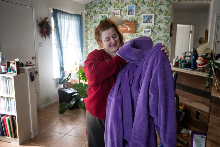 Annie O'Grady shows the Comfy she's been wearing to keep warm during the power outages.