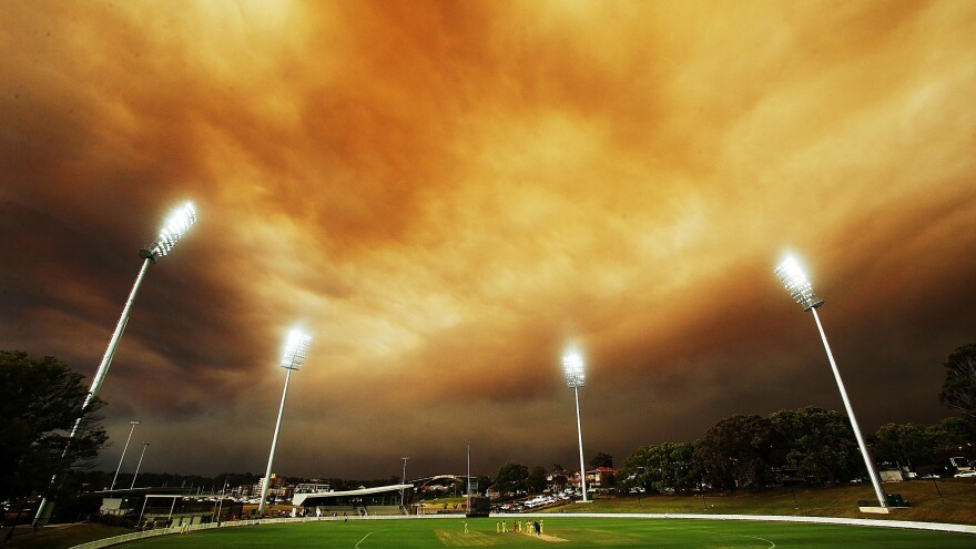 A general view of play as the Sydney skyline is shrouded in smoke during the Ryobi Cup match between the South Australian Redbacks and the Western Australia Warriors at Drummoyne Oval in Australia.